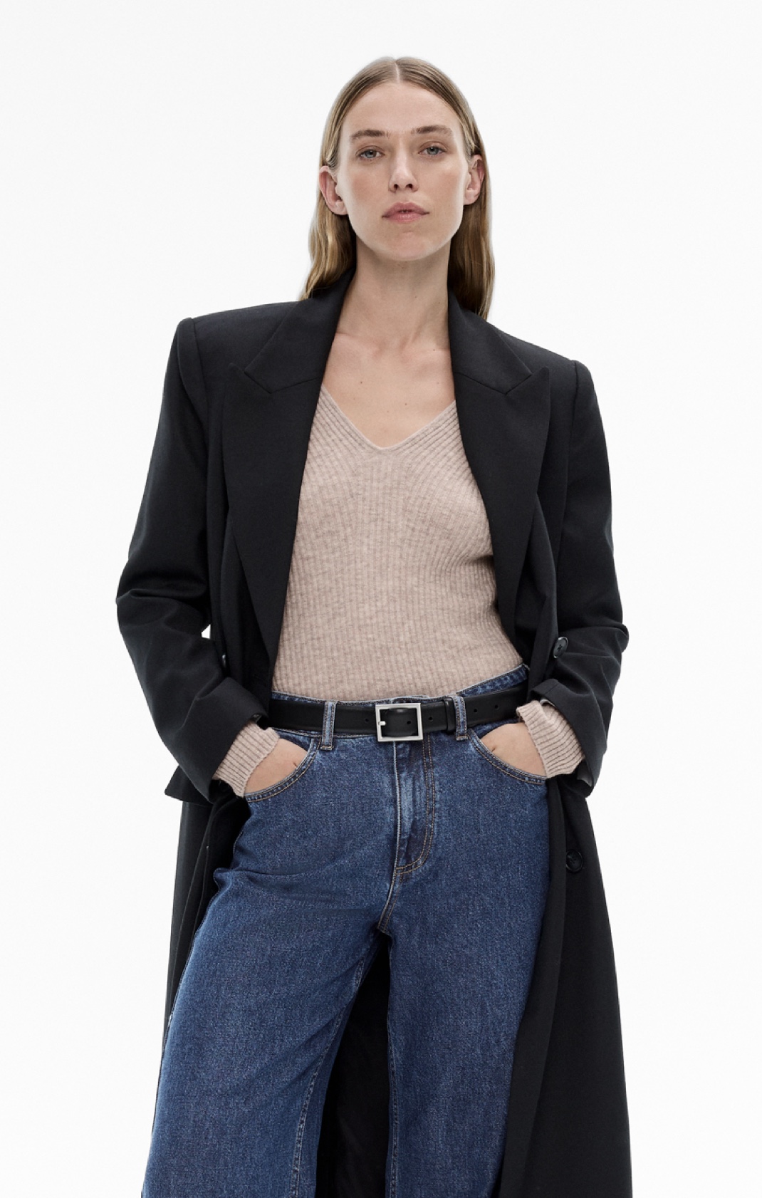 Woman in knit tank top, denim jeans and black blazer coat
