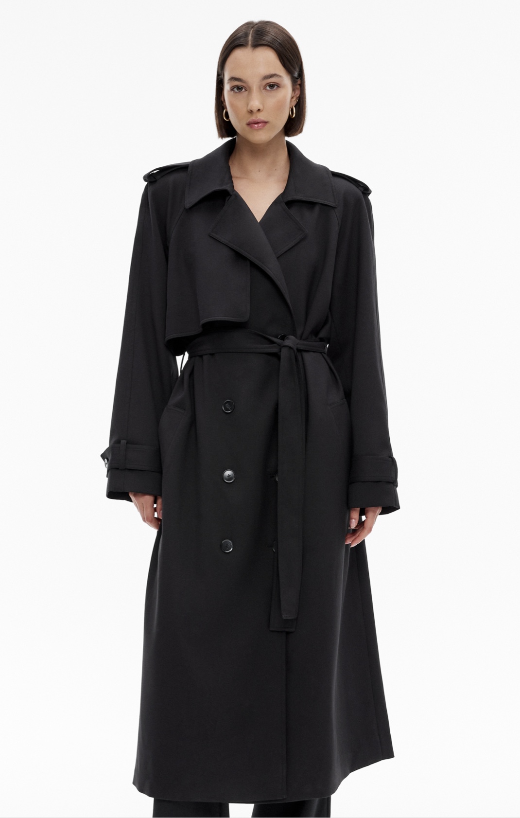 Woman in black trench coat