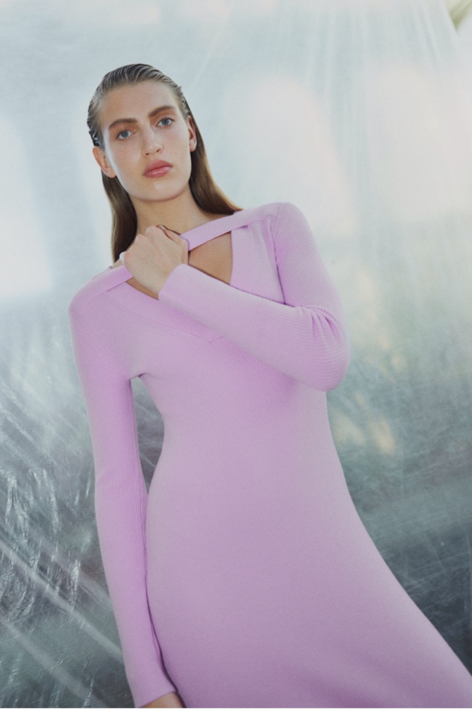 Woman in orchid pink knit v neck cut out dress