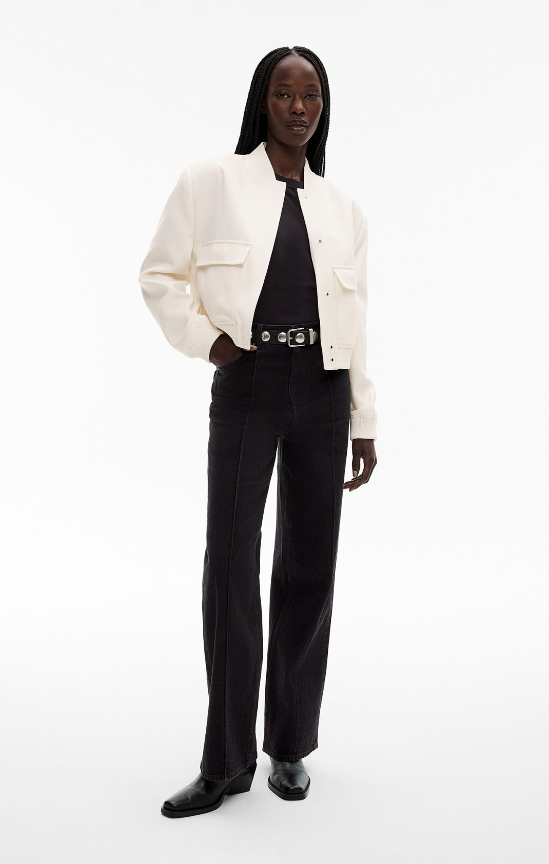 Woman in black top, white bomber jacket and black jeans