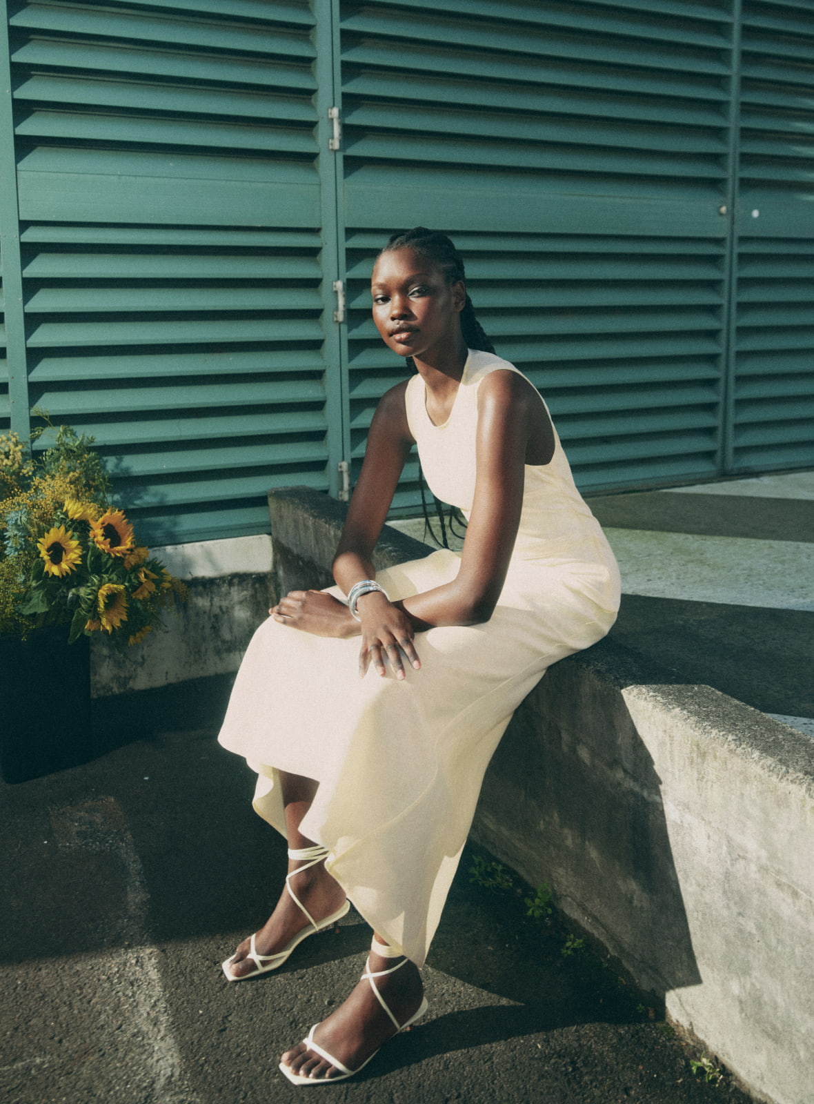Woman wearing the lemon waist tuck detail dress, lemon blair tie up heel and silver noa cuff