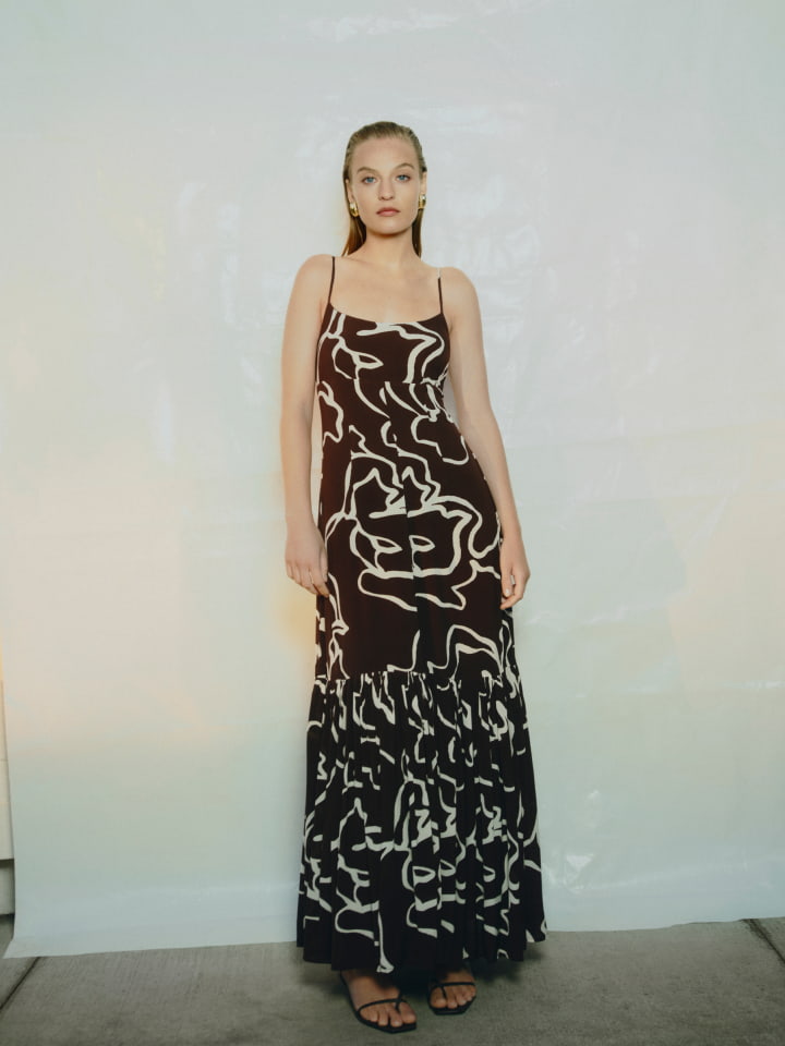 Woman in chocolate gather tier maxi dress and chocolate blair tie up heel