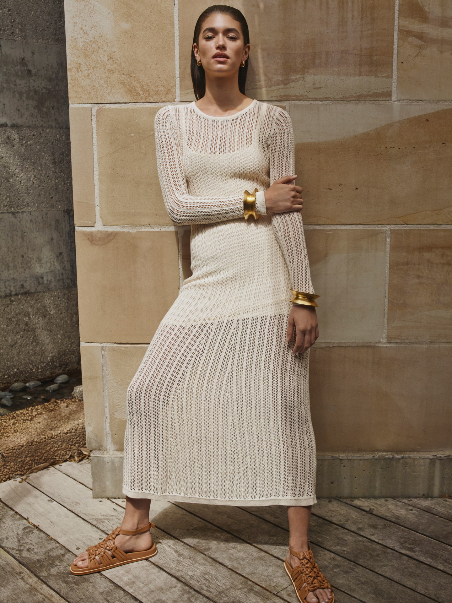 Woman in brown high neck cap sleeve tee, brown jersey maxi skirt and brown blair tie up heel